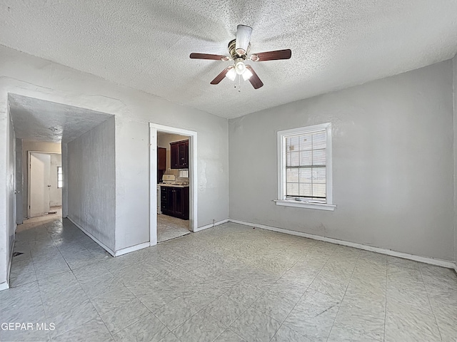 81 N Eucalyptus St, El Paso, TX 79901 - empty room with a wealth of natural light, a ceiling fan, light floors, and a textured ceiling