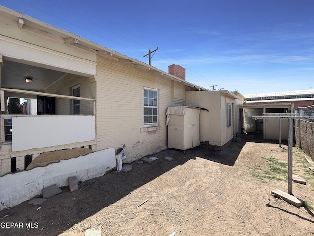81 N Eucalyptus St, El Paso, TX 79901 - back of property with a chimney, fence, and brick siding