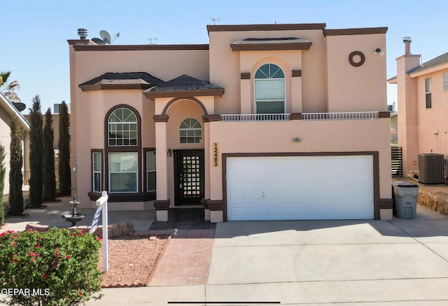 12482 Paseo Rojo Dr, El Paso, TX 79928 - view of front of property featuring central air condition unit, a garage, stucco siding, and driveway
