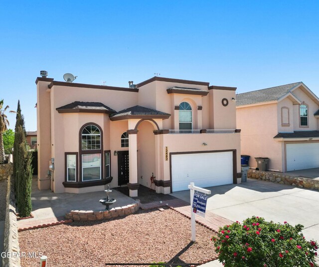 12482 Paseo Rojo Dr, El Paso, TX 79928 - mediterranean / spanish home with driveway, stucco siding, and an attached garage