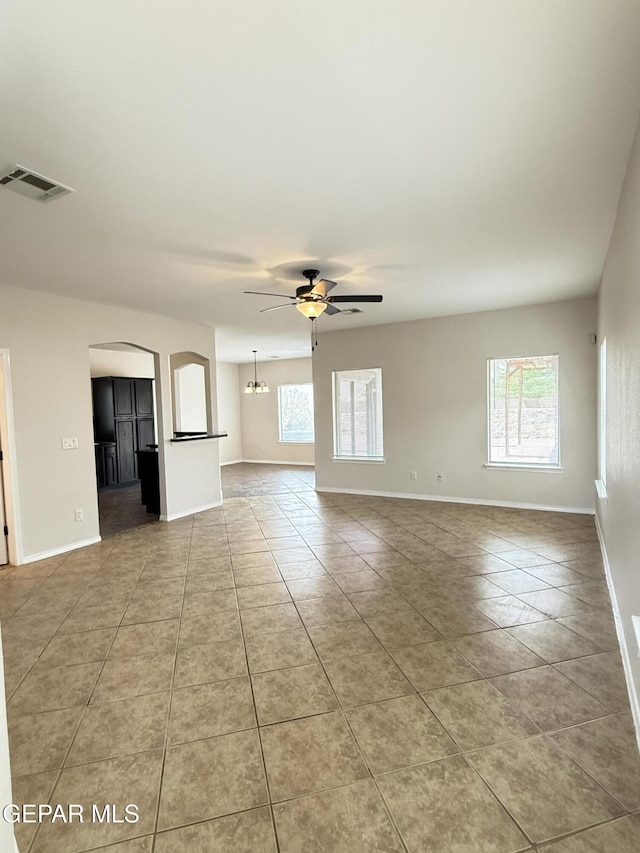 14368 N Cave Dr, El Paso, TX 79938 - unfurnished living room featuring tile patterned floors, plenty of natural light, visible vents, and a ceiling fan