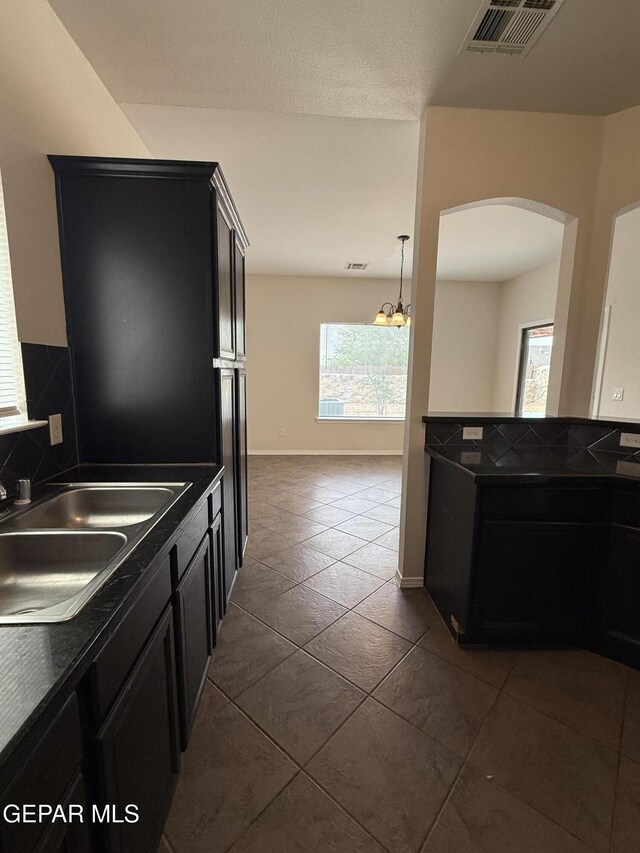 14368 N Cave Dr, El Paso, TX 79938 - kitchen with arched walkways, plenty of natural light, visible vents, and a sink