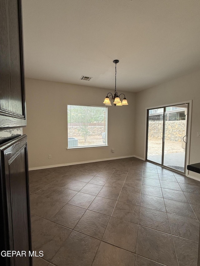 14368 N Cave Dr, El Paso, TX 79938 - unfurnished dining area with a wealth of natural light, a notable chandelier, visible vents, and dark tile patterned flooring