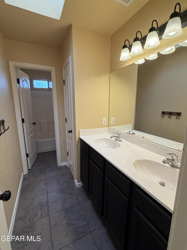 14368 N Cave Dr, El Paso, TX 79938 - bathroom featuring double vanity, baseboards, and a sink