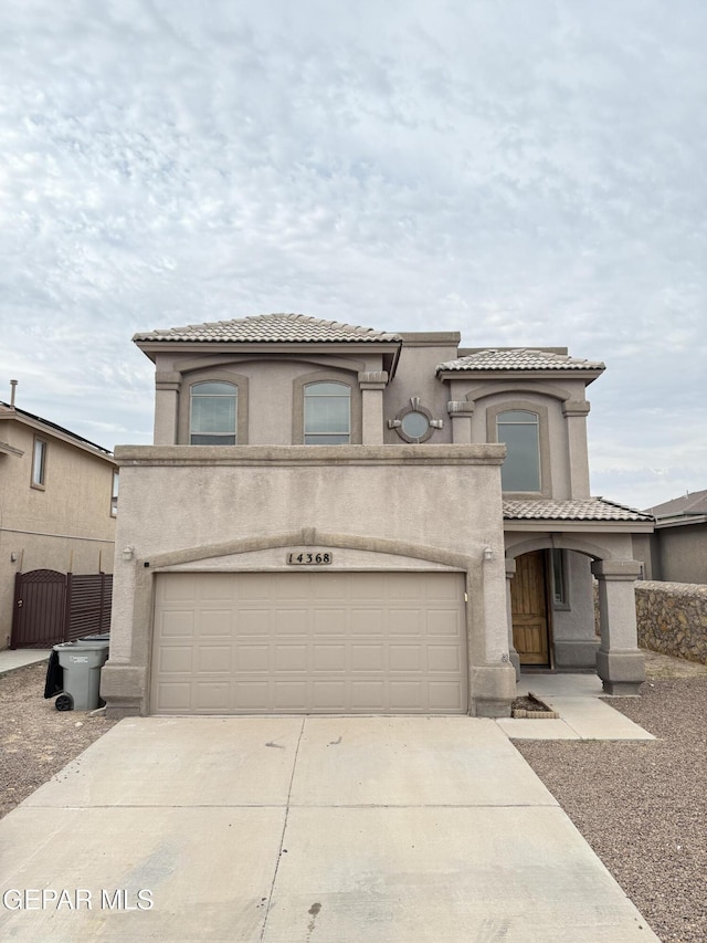 14368 N Cave Dr, El Paso, TX 79938 - mediterranean / spanish home with a tiled roof, stucco siding, a garage, and concrete driveway