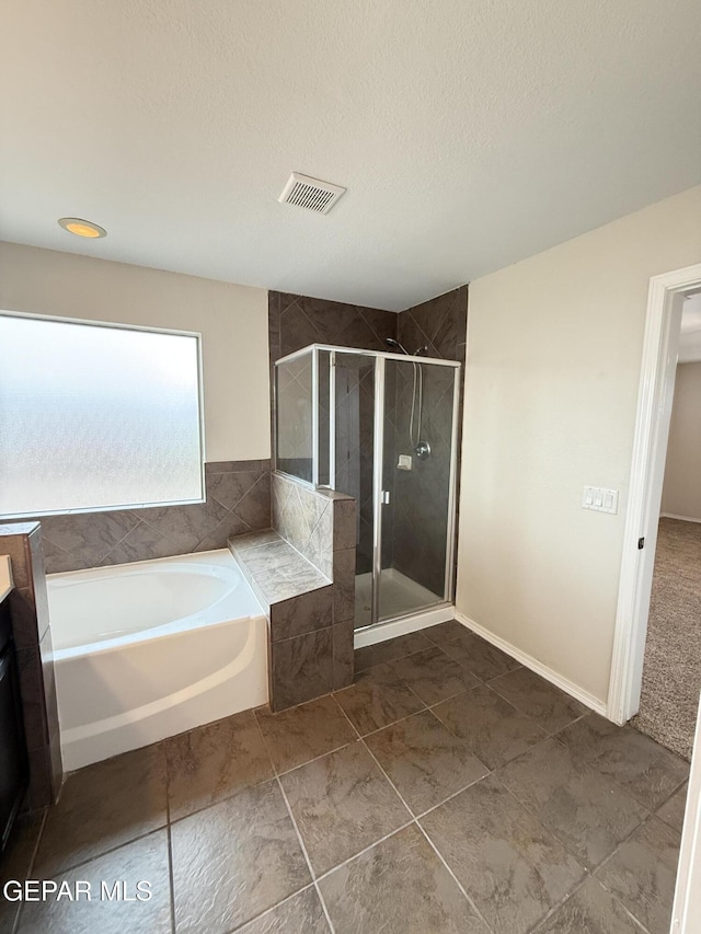 14368 N Cave Dr, El Paso, TX 79938 - bathroom featuring visible vents, a textured ceiling, tile patterned flooring, a stall shower, and a garden tub