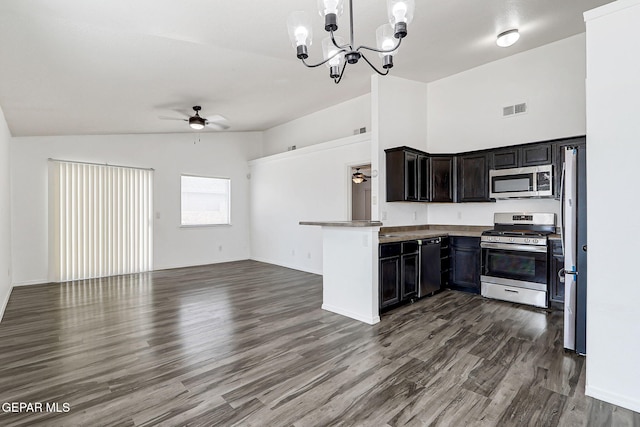 12729 Raul Mendiola Ln, El Paso, TX 79938 - kitchen featuring appliances with stainless steel finishes, a ceiling fan, open floor plan, vaulted ceiling, and dark wood-style floors