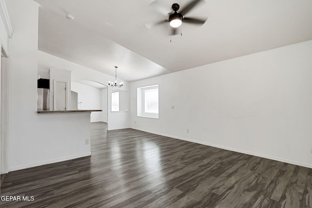 12729 Raul Mendiola Ln, El Paso, TX 79938 - unfurnished living room featuring a chandelier, dark wood finished floors, ceiling fan, vaulted ceiling, and baseboards