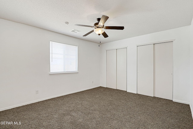 12729 Raul Mendiola Ln, El Paso, TX 79938 - unfurnished bedroom with multiple closets, carpet, a textured ceiling, a ceiling fan, and baseboards
