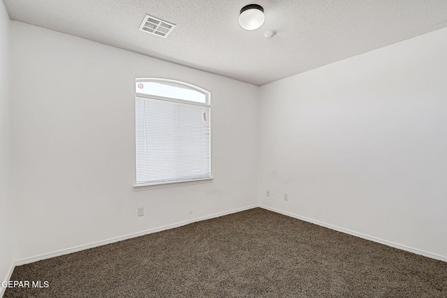12729 Raul Mendiola Ln, El Paso, TX 79938 - unfurnished room with dark carpet, a textured ceiling, and baseboards