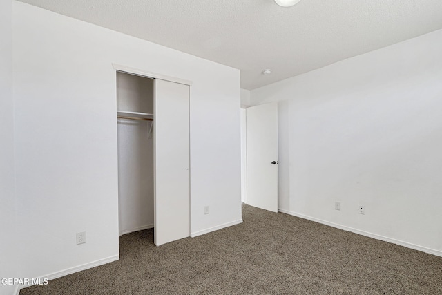 12729 Raul Mendiola Ln, El Paso, TX 79938 - unfurnished bedroom with dark colored carpet, a closet, and baseboards
