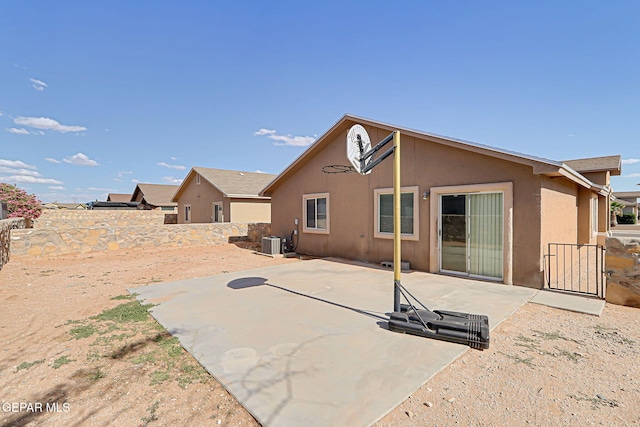12729 Raul Mendiola Ln, El Paso, TX 79938 - back of property with central AC, a fenced backyard, stucco siding, and a patio