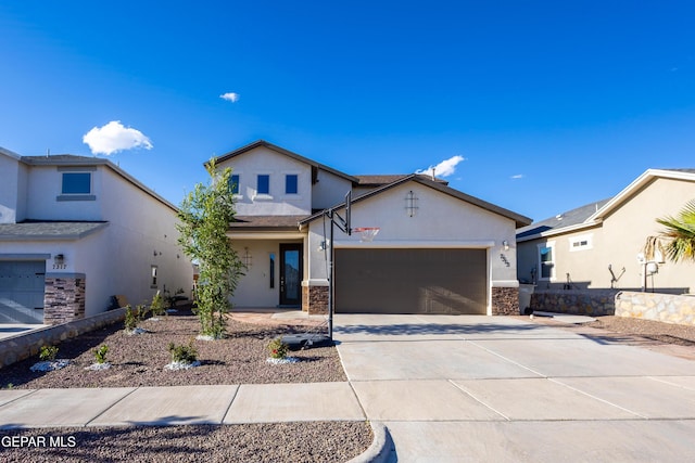 view of front of house with stucco siding, an attached garage, driveway, and stone siding