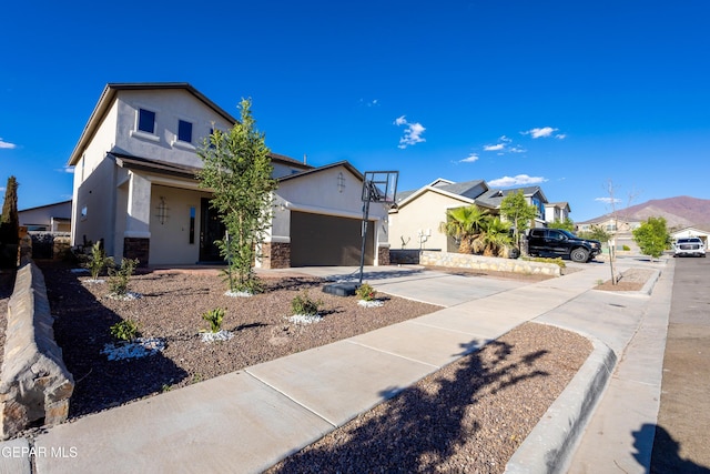 view of front of house with stucco siding, driveway, stone siding, and a residential view