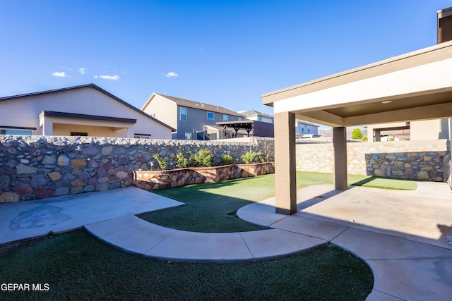 fenced backyard featuring a patio