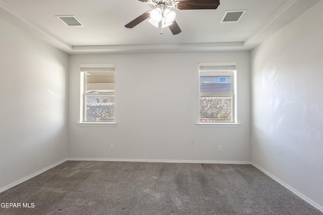 carpeted empty room featuring ceiling fan and baseboards