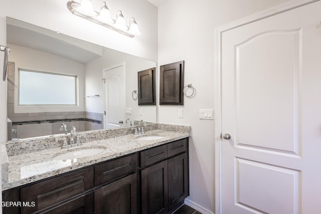 full bathroom featuring double vanity and a tub