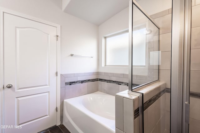 bathroom featuring a shower stall and a garden tub