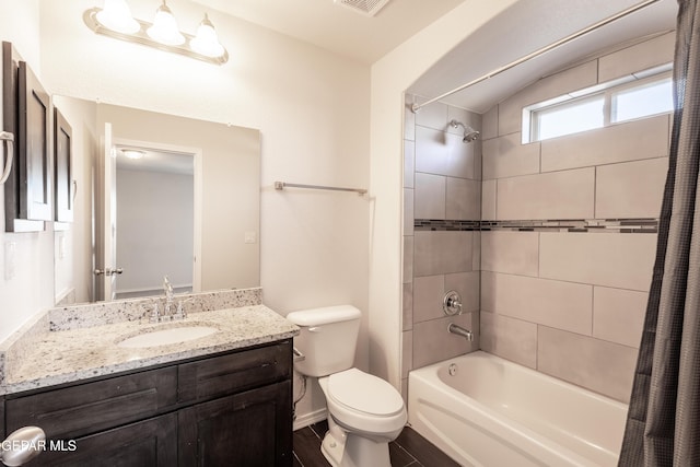 bathroom featuring toilet, shower / bath combination with curtain, vanity, and baseboards