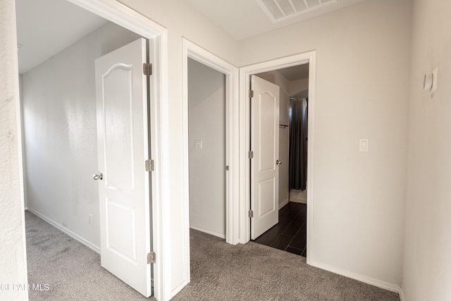 corridor with carpet flooring and baseboards