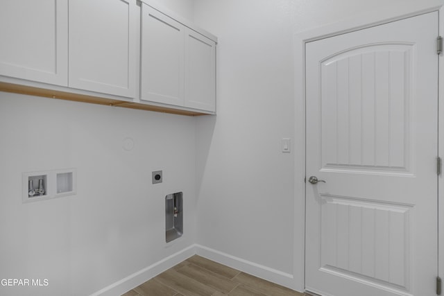 washroom with wood finished floors, hookup for an electric dryer, cabinet space, baseboards, and washer hookup