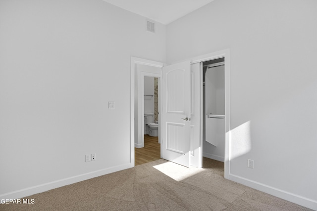 unfurnished bedroom featuring baseboards, carpet floors, visible vents, and a closet