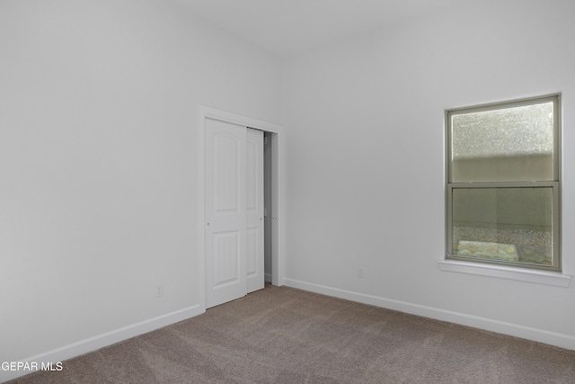 spare room with carpet floors and baseboards