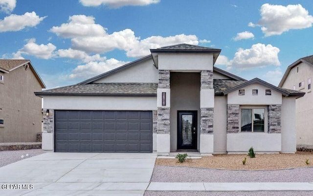 view of front of house featuring an attached garage, concrete driveway, stone siding, and stucco siding