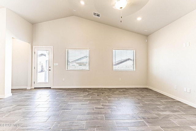 unfurnished living room with lofted ceiling, a wealth of natural light, visible vents, and a ceiling fan