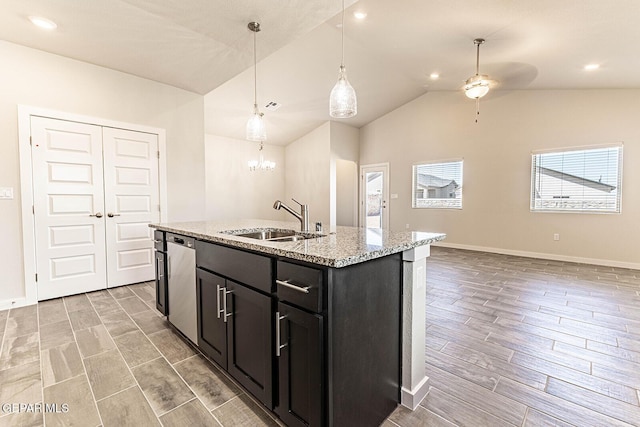 kitchen featuring stainless steel dishwasher, light wood-style flooring, dark cabinets, a sink, and ceiling fan with notable chandelier