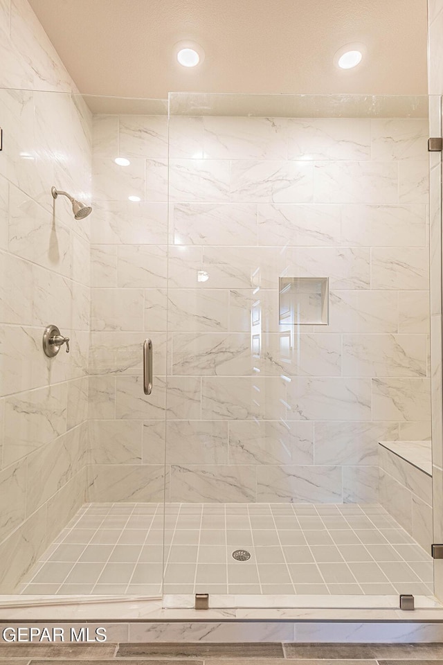 bathroom featuring recessed lighting and a shower stall
