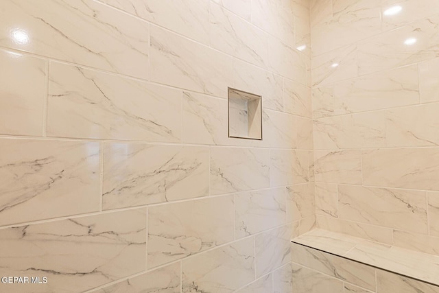 bathroom with tiled shower