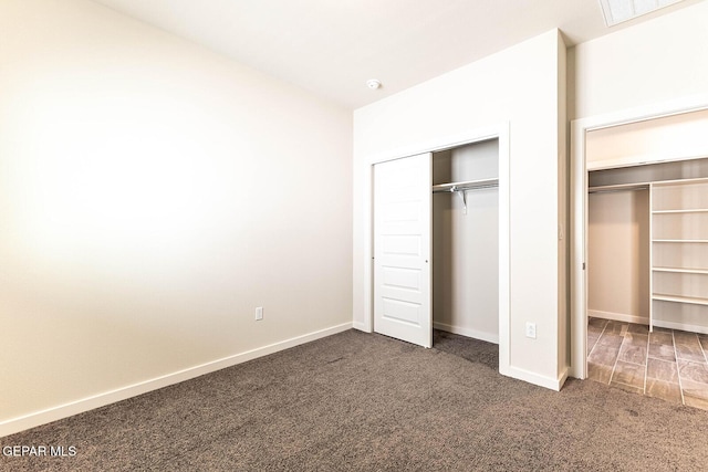 unfurnished bedroom featuring carpet, visible vents, and baseboards