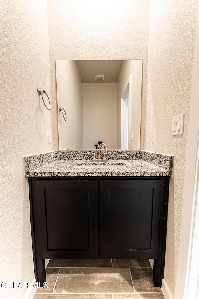 bathroom with visible vents and vanity