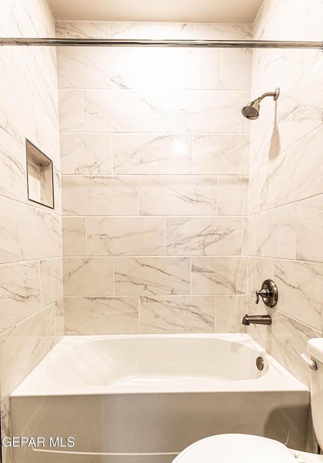 bathroom featuring toilet and shower / washtub combination