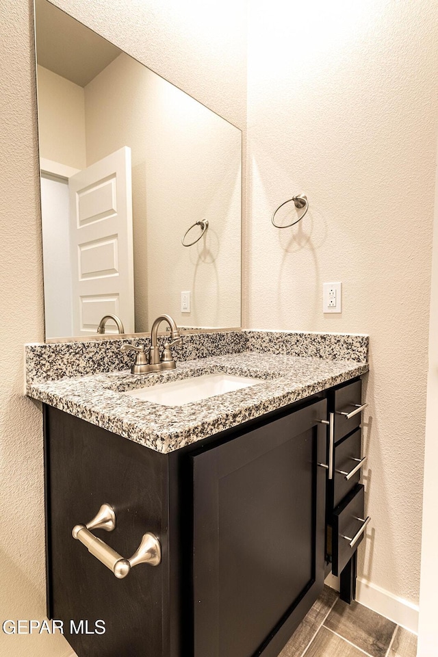 bathroom with vanity and baseboards