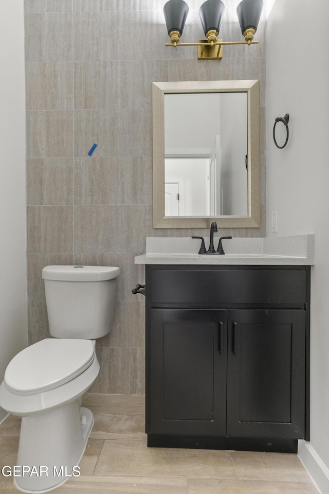 813 Durham Way, Horizon City, TX 79928 - bathroom with baseboards, vanity, and toilet