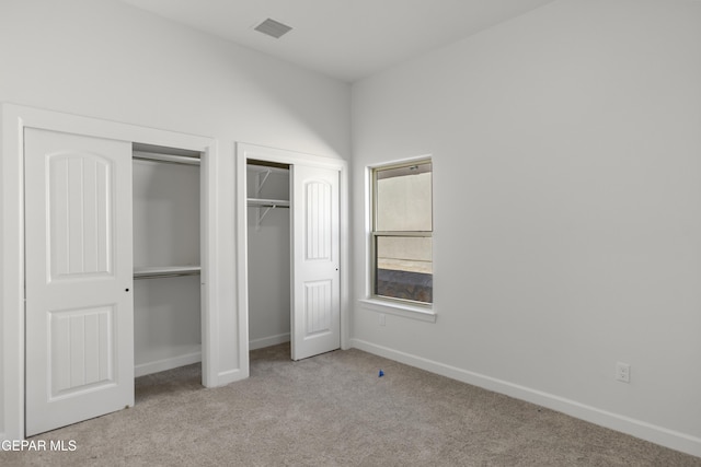 813 Durham Way, Horizon City, TX 79928 - unfurnished bedroom featuring two closets, visible vents, baseboards, and carpet