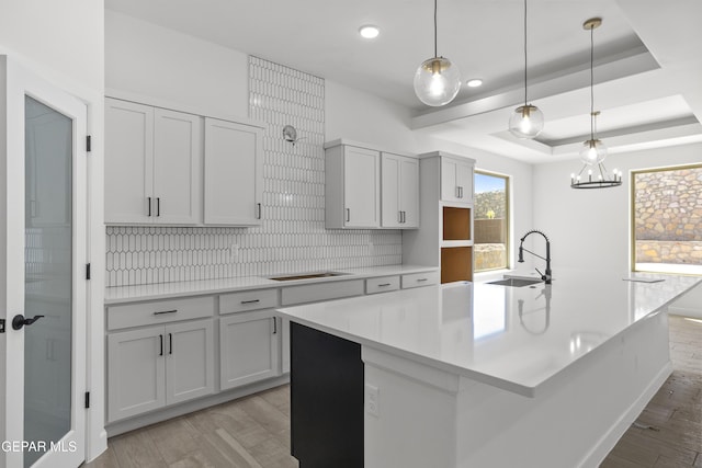 813 Durham Way, Horizon City, TX 79928 - kitchen featuring backsplash, a spacious island, a sink, and light wood-style floors