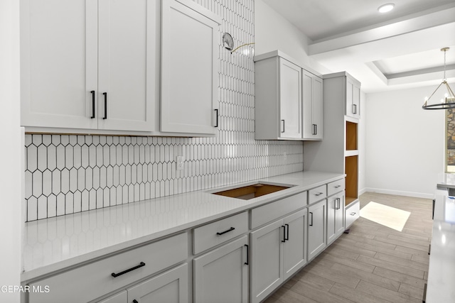 813 Durham Way, Horizon City, TX 79928 - kitchen with a chandelier, light wood-style floors, light countertops, backsplash, and baseboards