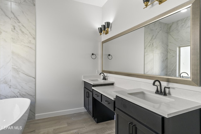 813 Durham Way, Horizon City, TX 79928 - full bathroom with a freestanding bath, double vanity, wood finished floors, and a sink