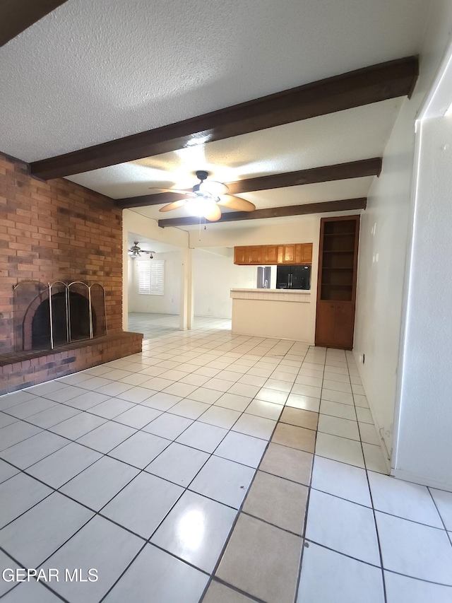 10850 Valle Grande Ct, El Paso, TX 79935 - unfurnished living room with beam ceiling, a fireplace, a textured ceiling, light tile patterned floors, and ceiling fan