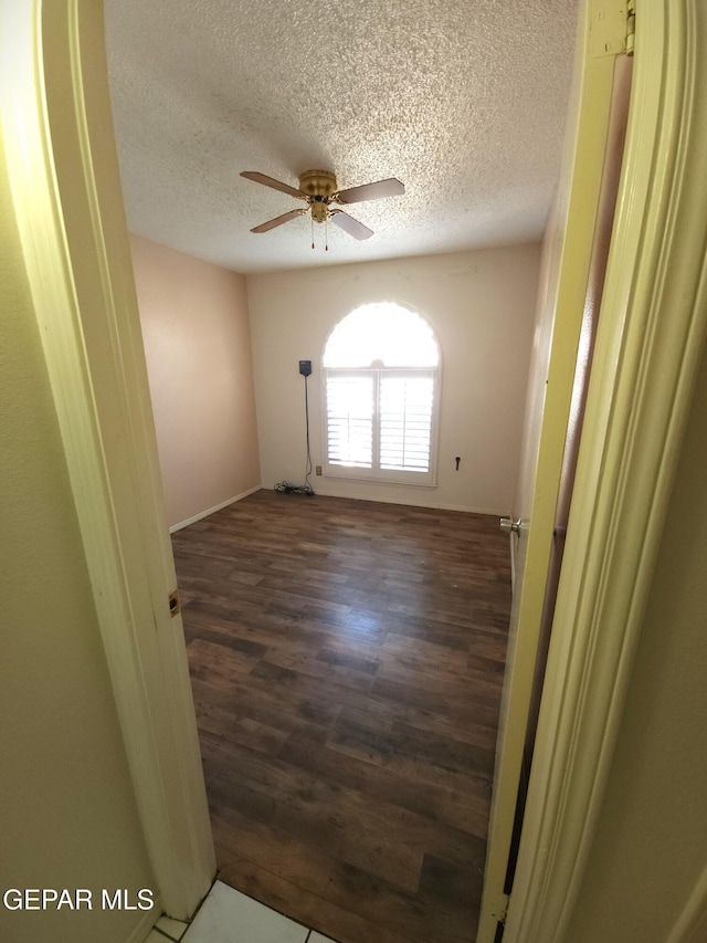 10850 Valle Grande Ct, El Paso, TX 79935 - empty room featuring wood finished floors, ceiling fan, a textured ceiling, and baseboards