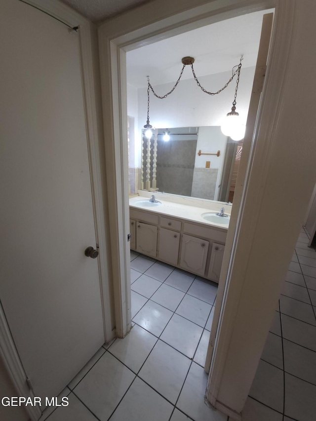 10850 Valle Grande Ct, El Paso, TX 79935 - bathroom with tile patterned floors and double vanity