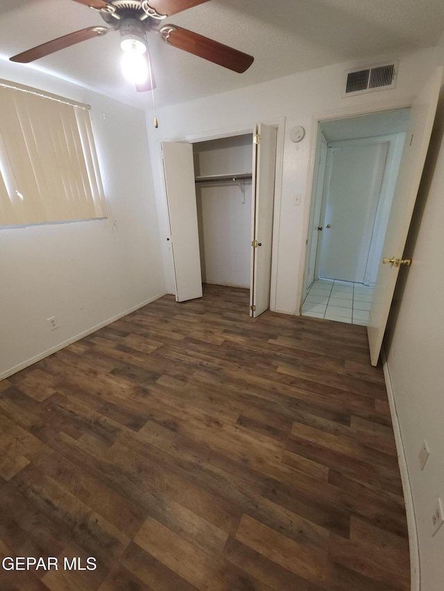 10850 Valle Grande Ct, El Paso, TX 79935 - unfurnished bedroom with wood finished floors, a closet, and ceiling fan