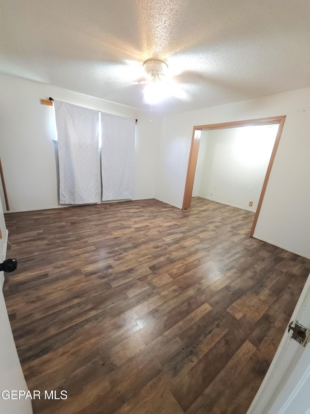 10850 Valle Grande Ct, El Paso, TX 79935 - spare room featuring wood finished floors, a ceiling fan, and a textured ceiling