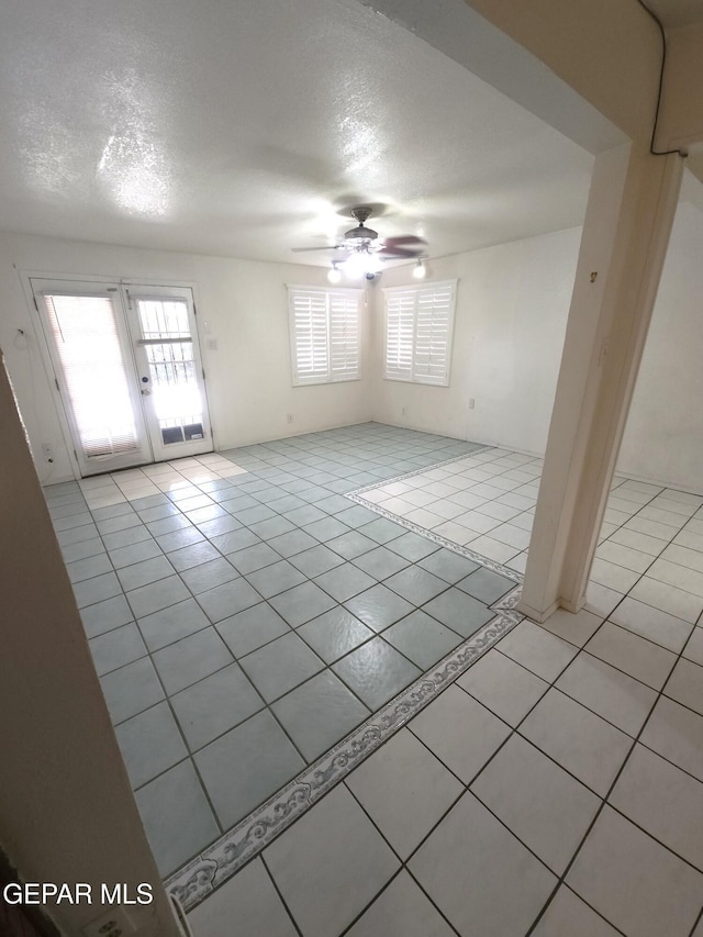 10850 Valle Grande Ct, El Paso, TX 79935 - unfurnished room featuring light tile patterned flooring, ceiling fan, french doors, and a textured ceiling