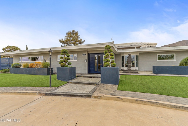701 La Cruz Dr, El Paso, TX 79902 - view of front of home featuring brick siding, a front lawn, and a tiled roof