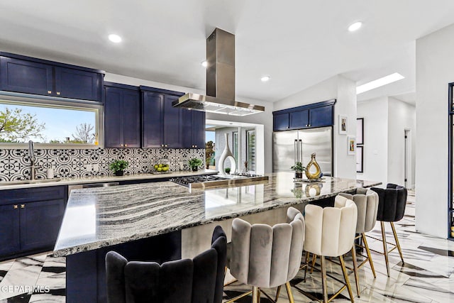 701 La Cruz Dr, El Paso, TX 79902 - kitchen with a sink, island exhaust hood, light stone counters, appliances with stainless steel finishes, and blue cabinets