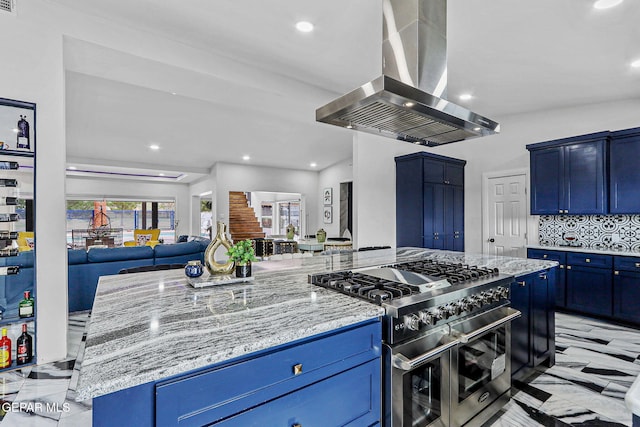 701 La Cruz Dr, El Paso, TX 79902 - kitchen with open floor plan, double oven range, light stone countertops, island range hood, and blue cabinets
